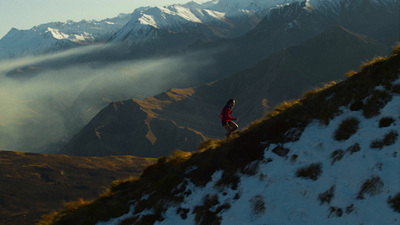 a person standing on top of a snow covered mountain