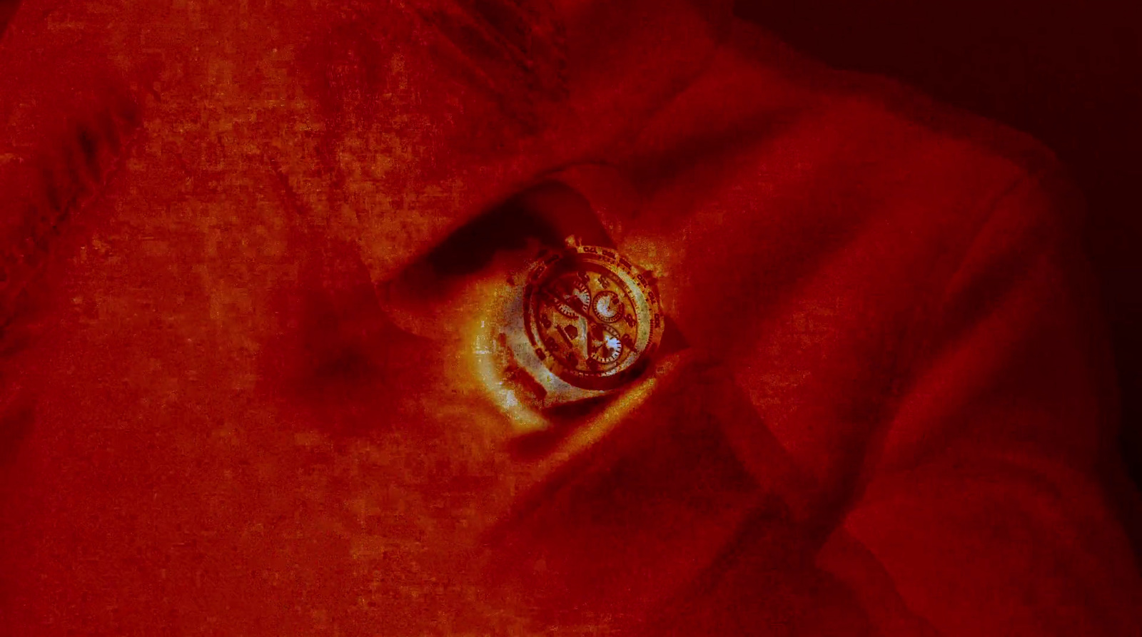 a close up of a button on a red shirt