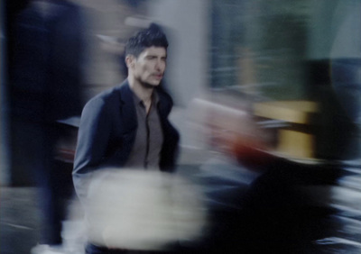 a blurry photo of a man walking down the street