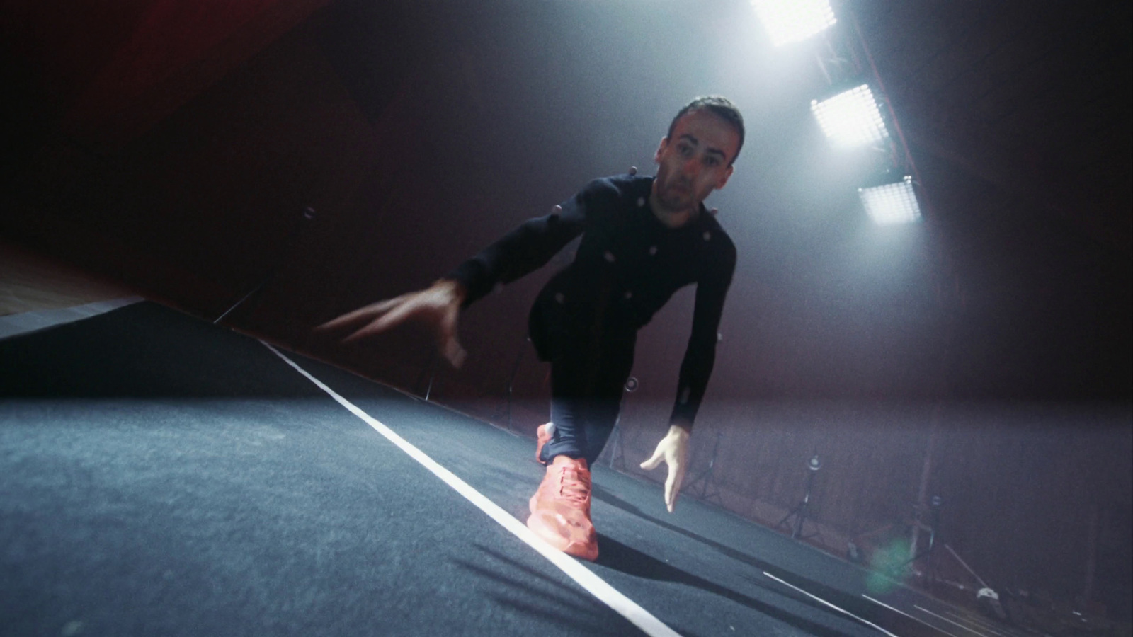 a man is running on a track in the dark