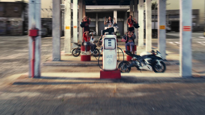 a group of people sitting on top of gas pumps