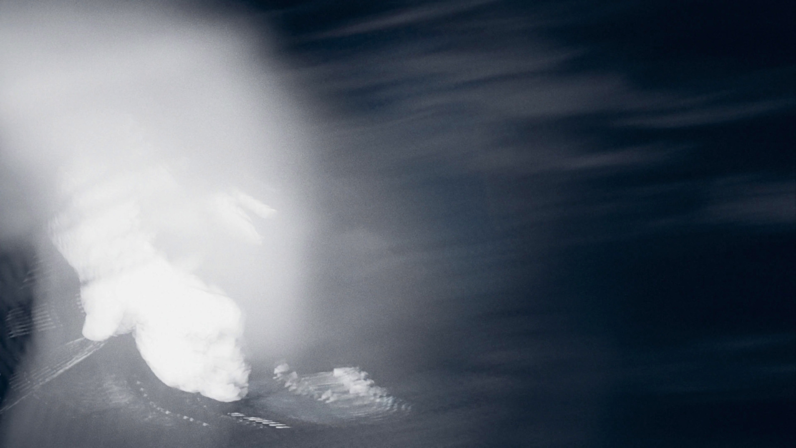 a blurry photo of a person on a snowboard