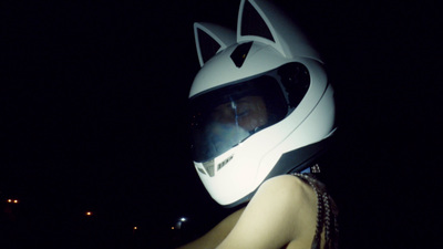 a person wearing a helmet with a cat design on it