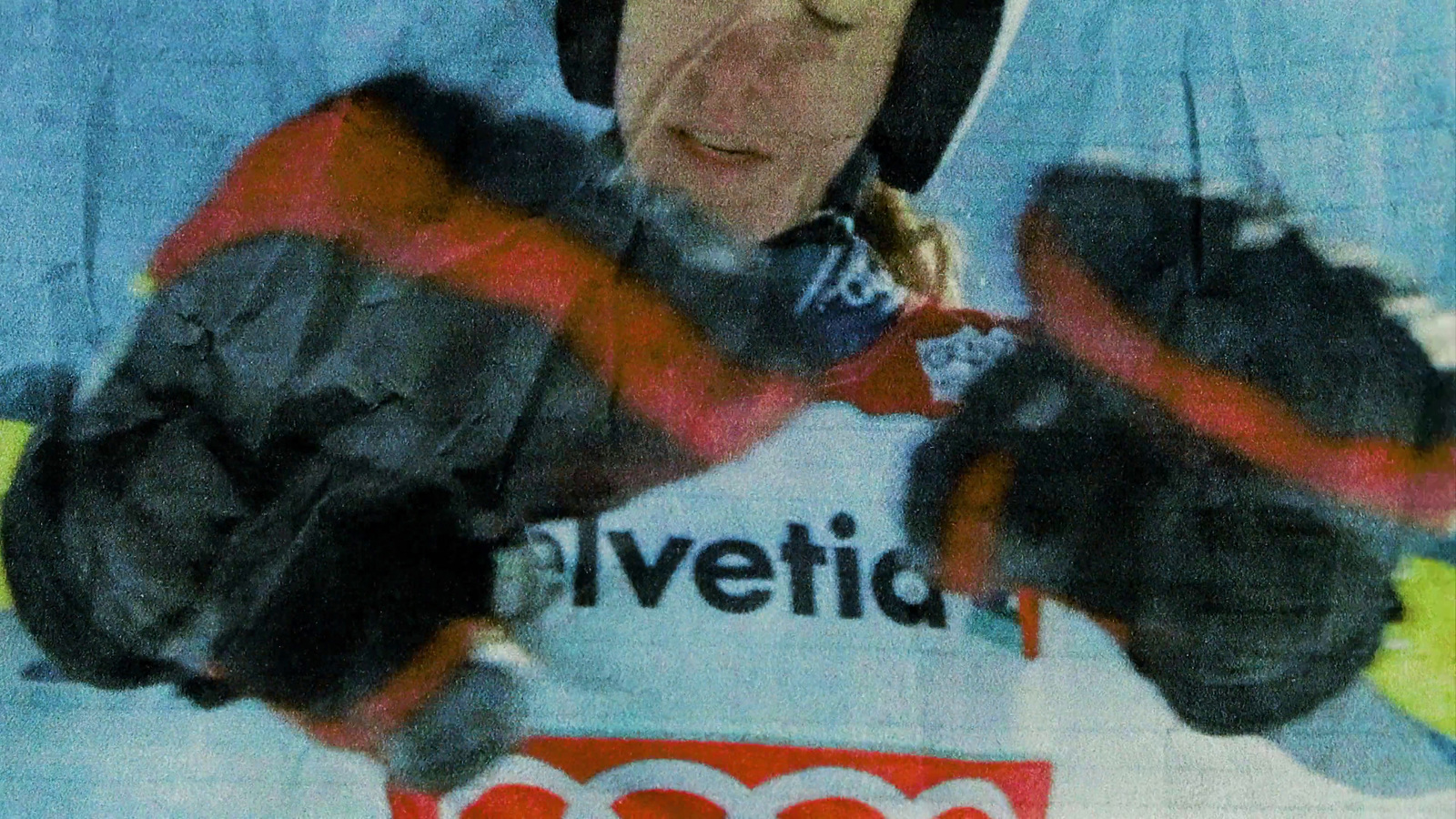 a woman in a red and black jacket holding a pair of skis