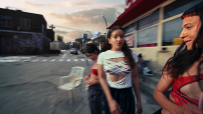 a couple of women standing next to each other on a street