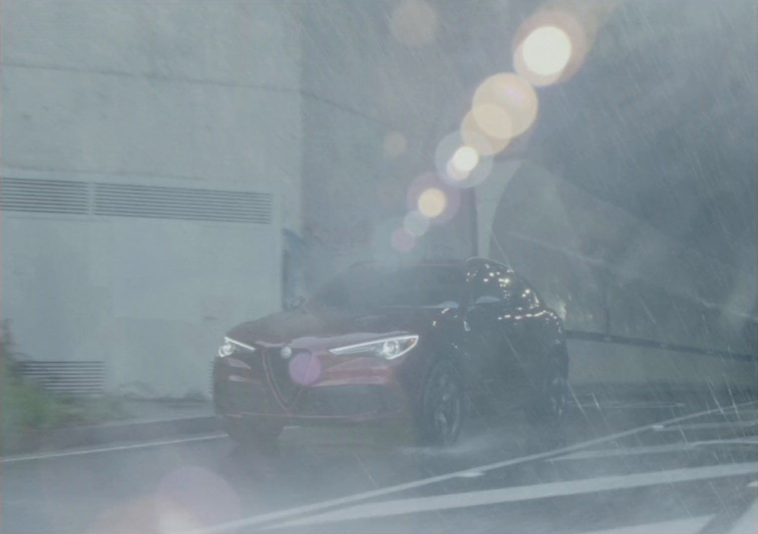 a car driving down a street in the rain