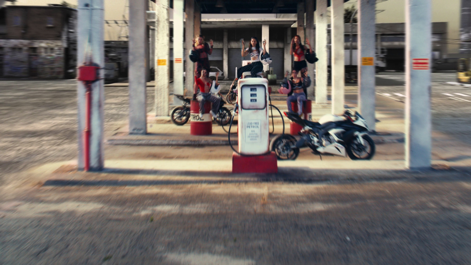 a group of people standing around a gas station