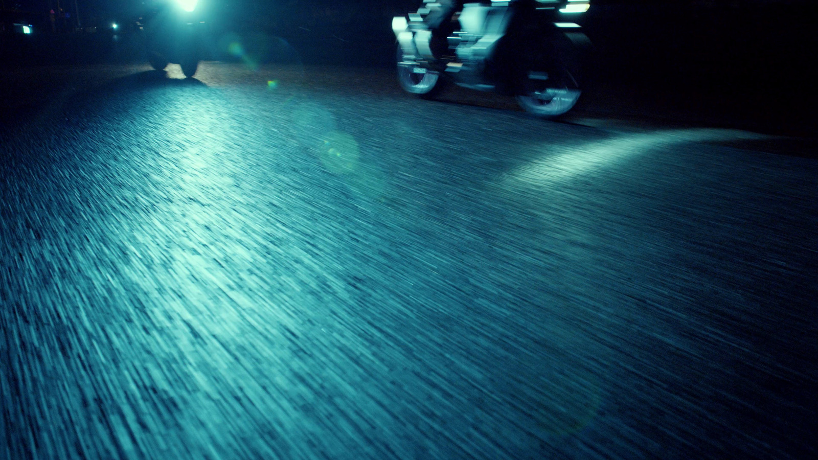 a person riding a skateboard down a street at night