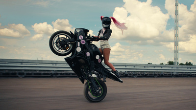 a woman riding on the back of a motorcycle