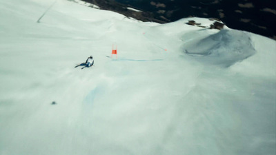 a man riding skis down a snow covered slope