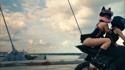 a woman sitting on the back of a motorcycle