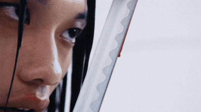 a close up of a person holding a knife