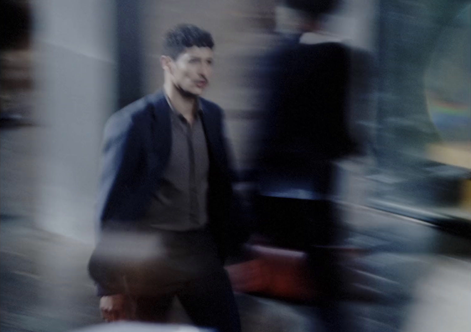 a blurry photo of a man walking down the street