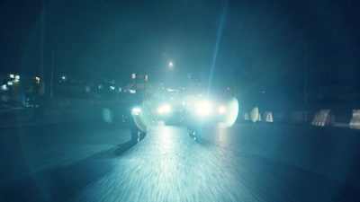 a man riding a skateboard down a street at night