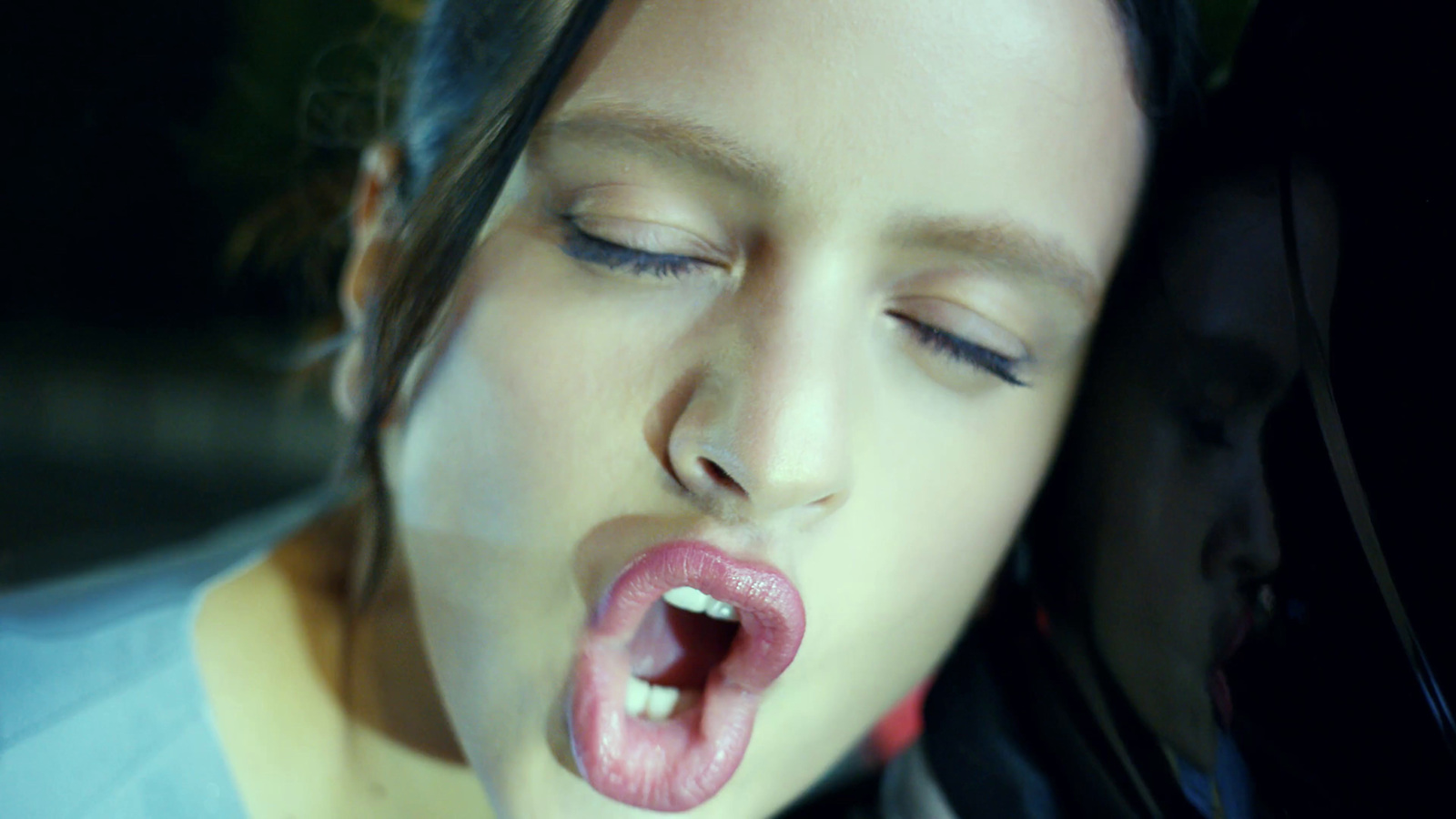 a woman sticking her tongue out with her eyes closed