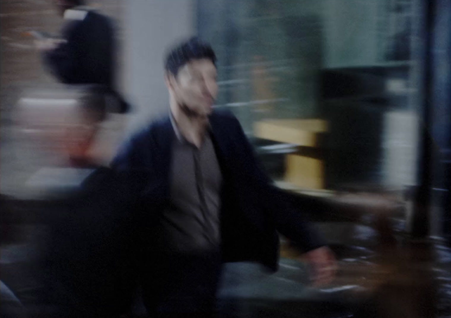 a blurry photo of a man walking down a street