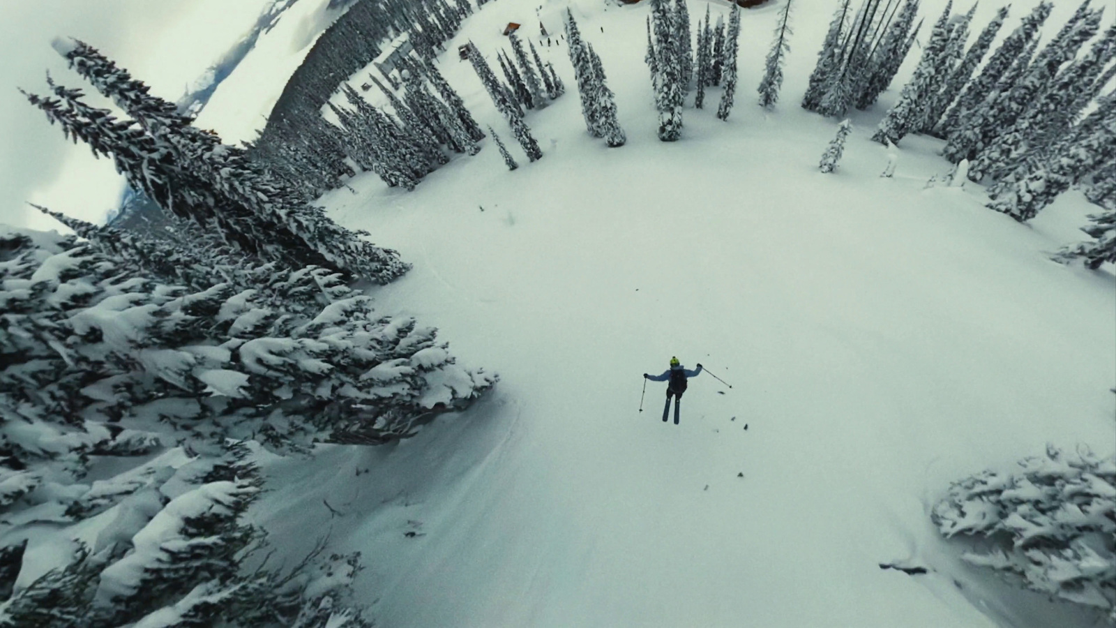 a person on skis in the middle of a snowy area