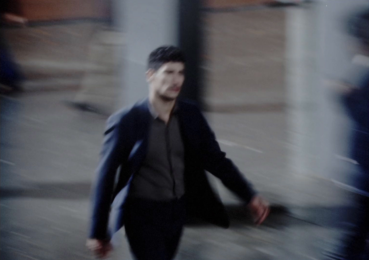 a blurry photo of a man walking down the street