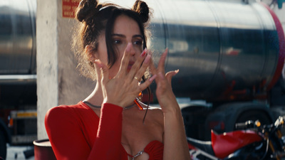 a woman in a red dress is covering her face