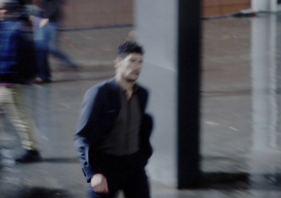 a blurry photo of a man walking down the street