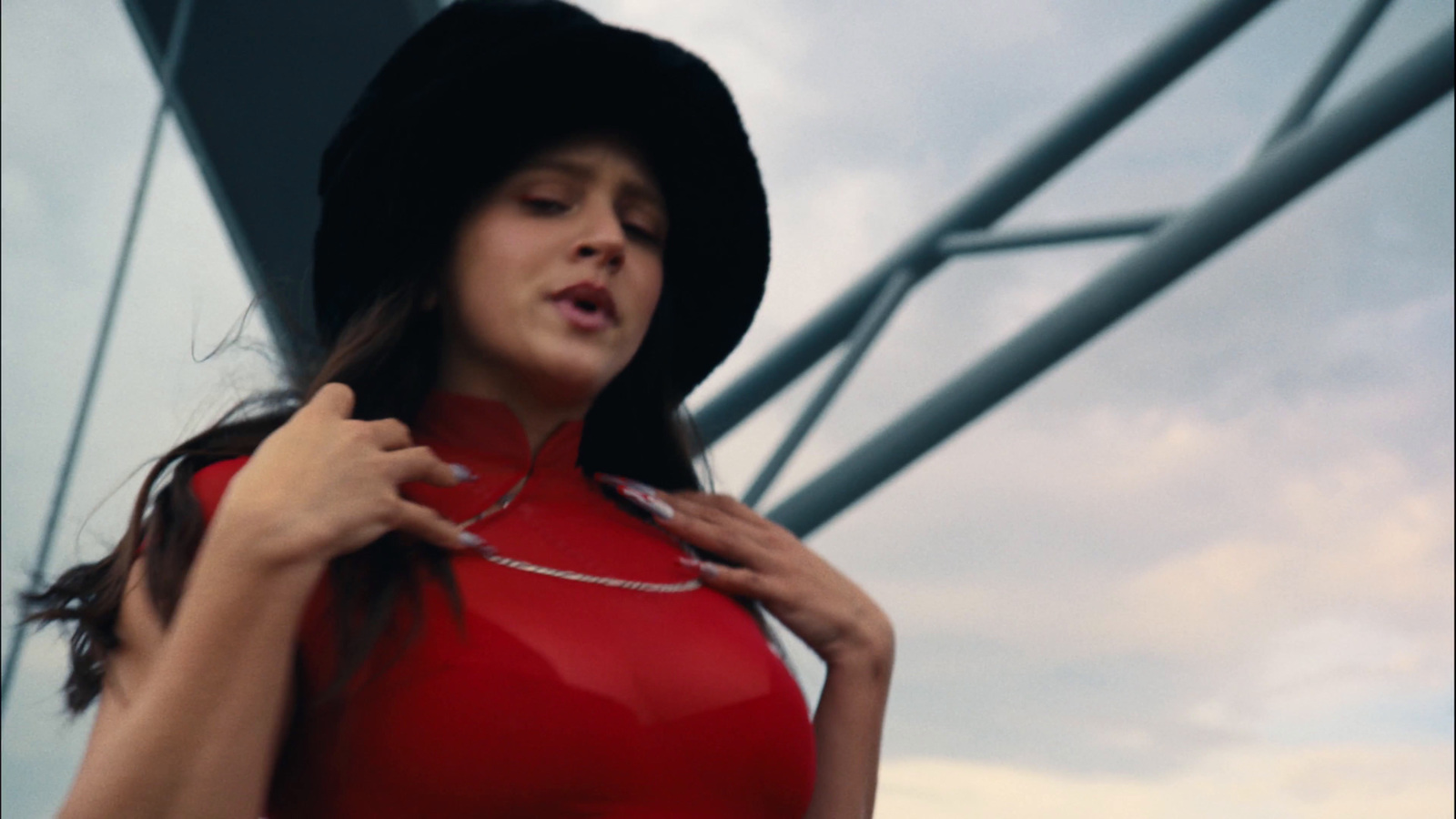 a woman in a red dress and a black hat