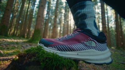 a person standing on a log in the woods