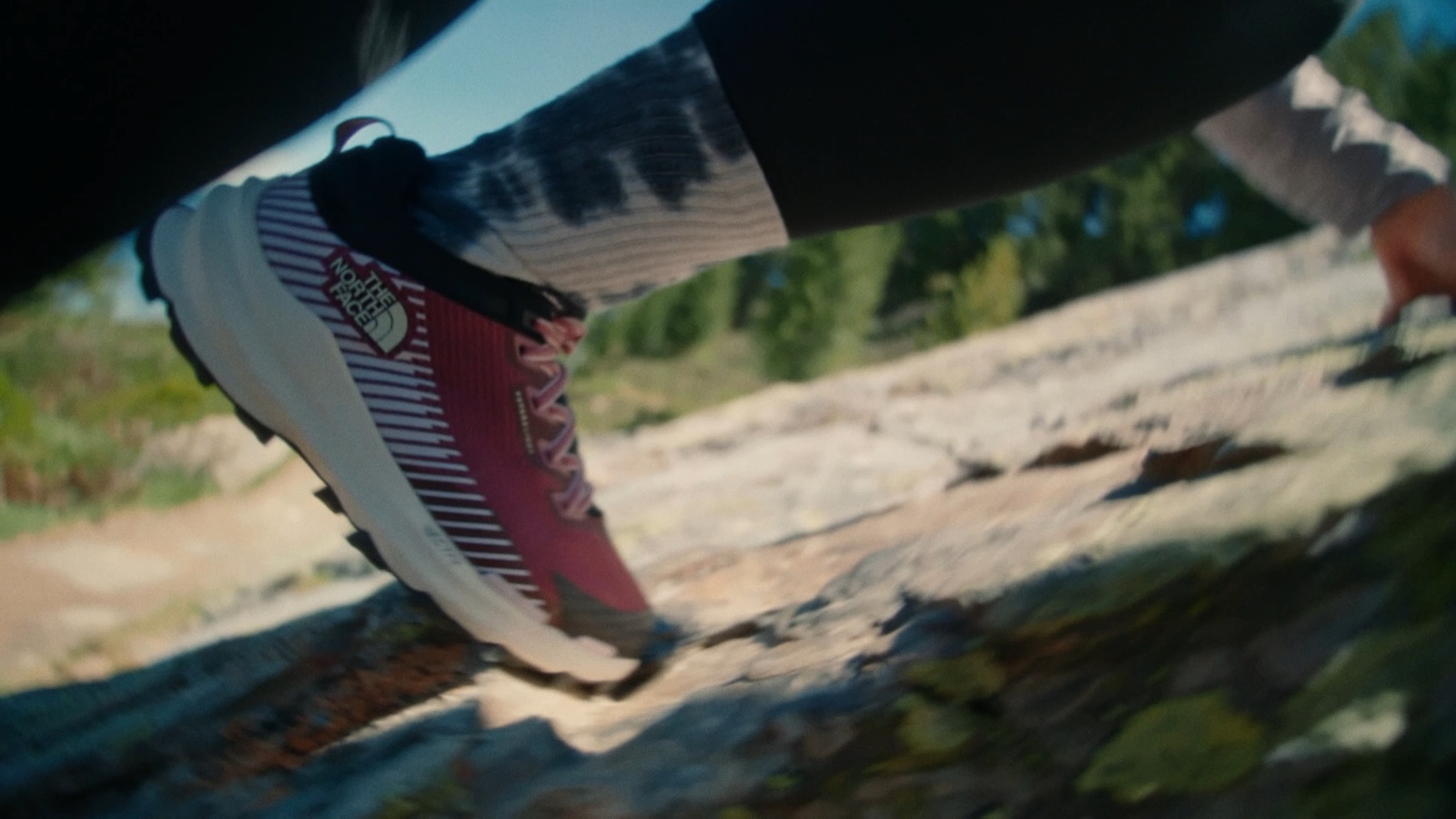 a close up of a person's shoes on a rock