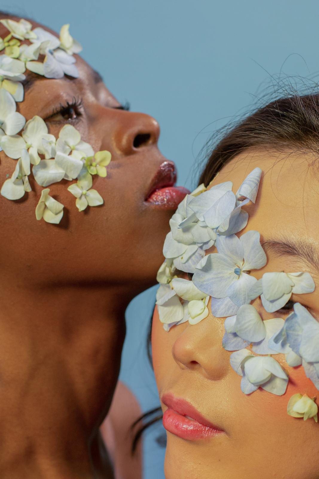 two women with flowers painted on their faces