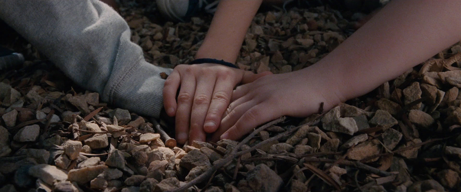 a close up of two people holding hands