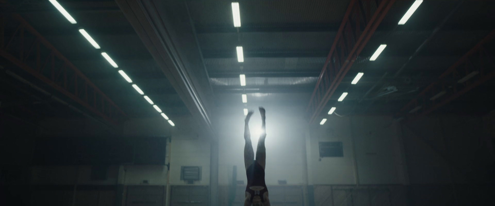 a person doing a handstand in a dark room