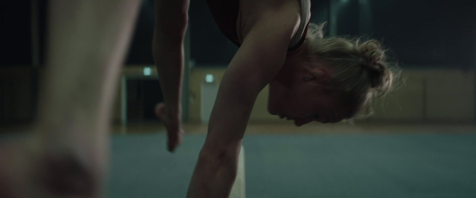 a woman is doing a handstand on a pole