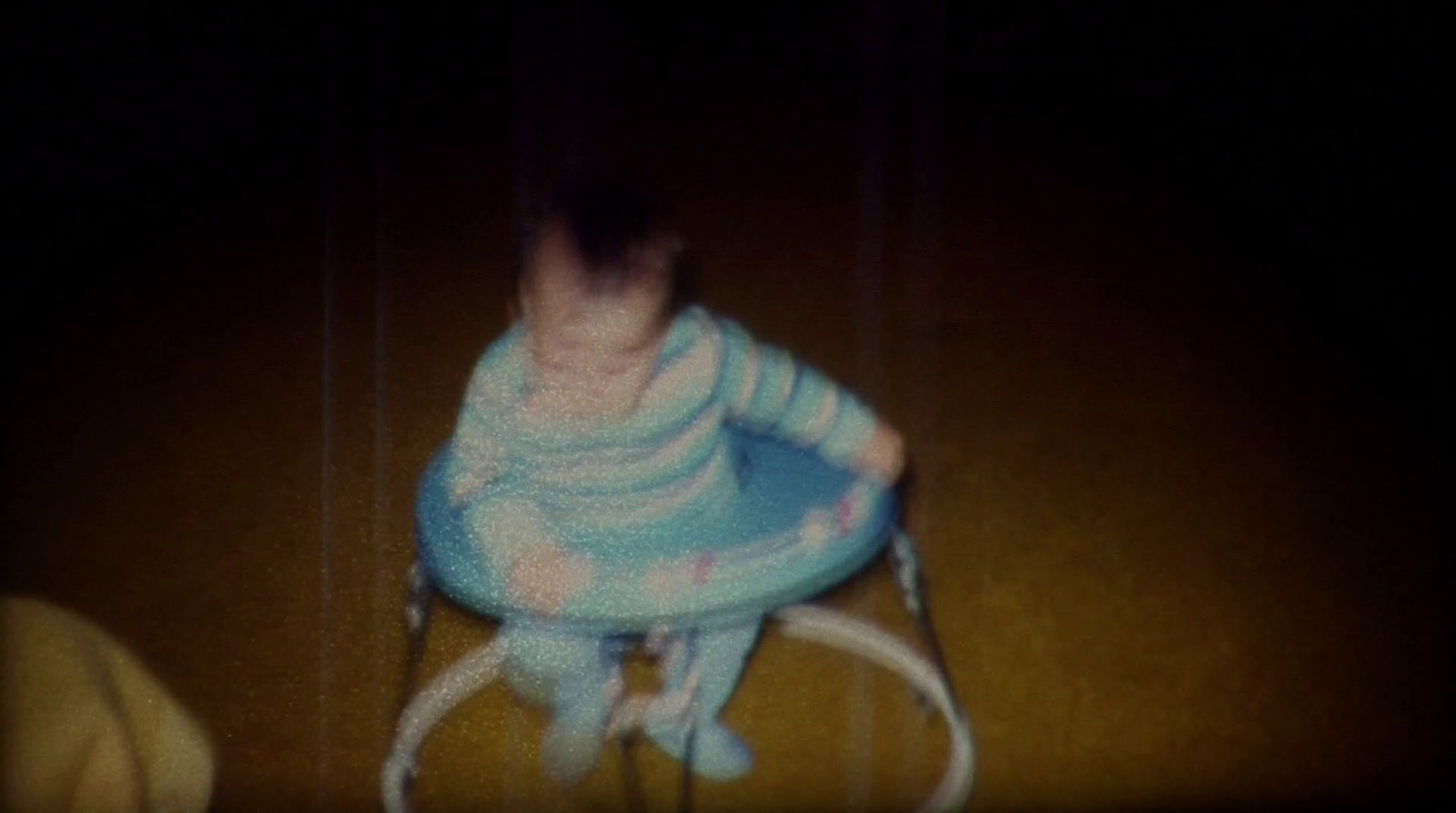 a blurry photo of a child on a chair