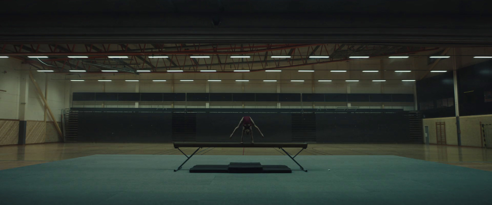 an empty gym with a bench in the middle