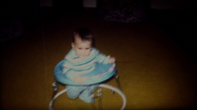 a baby sitting in a high chair on the floor