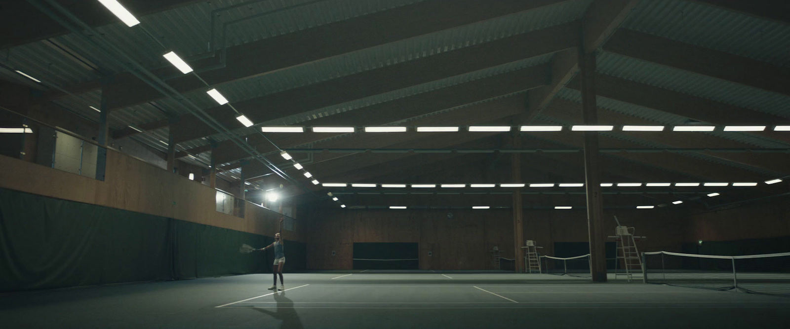 a person standing on a tennis court holding a racquet