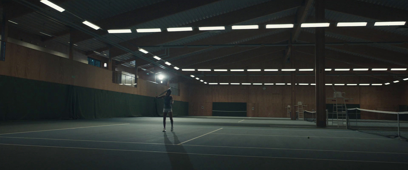 a man standing on a tennis court holding a racquet