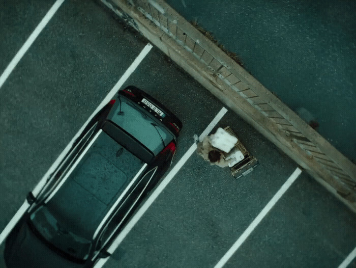 a car parked in a parking lot next to a curb