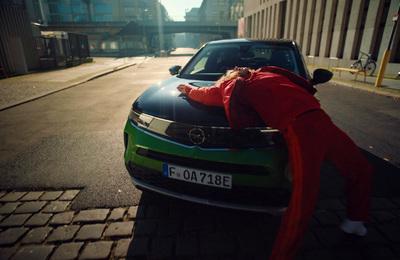 a person leaning on the hood of a car