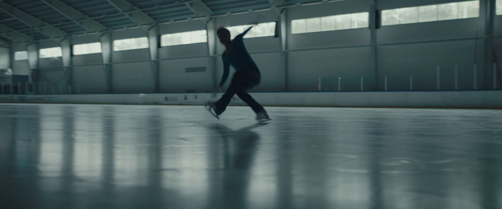 a woman in a black bodysuit is dancing