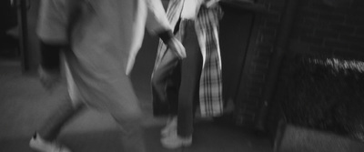 a black and white photo of a person walking