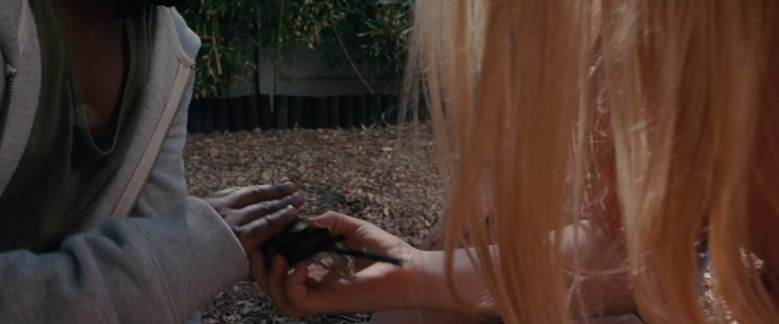 a woman holding a cell phone to another woman's hand