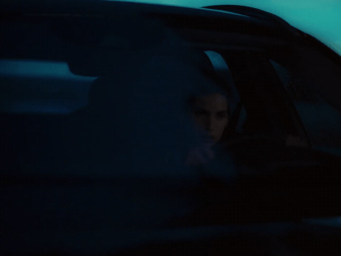 a woman sitting in the passenger seat of a car