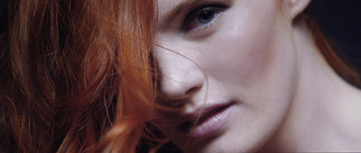 a close up of a woman with red hair