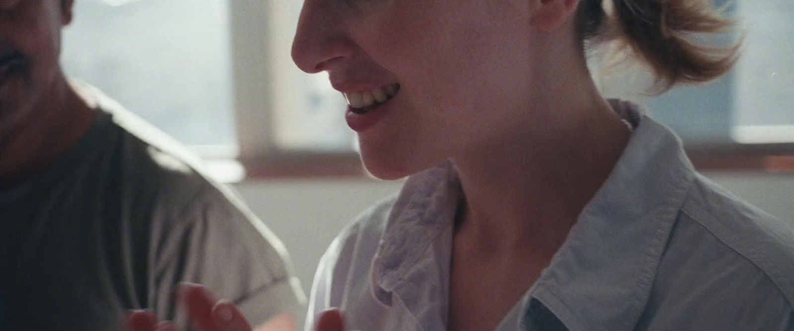 a man and a woman laughing together in a room