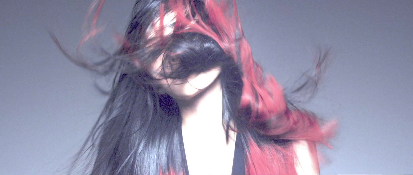 a woman with long black and red hair