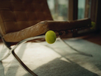 a tennis ball sitting on top of a chair