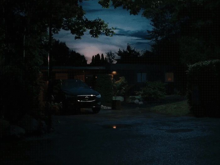 a car parked in front of a house at night