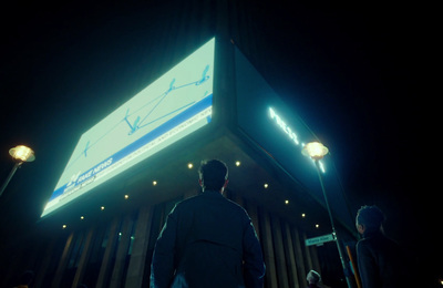 a man standing in front of a building at night