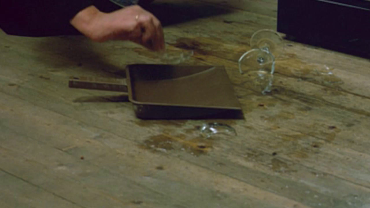 a person bending over a pan on a wooden floor