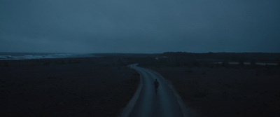 a person walking down a road at night